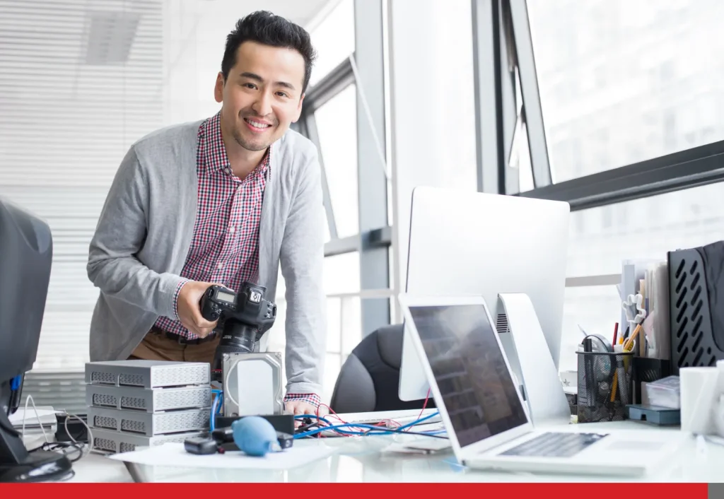 Photographer holding a camera in the office