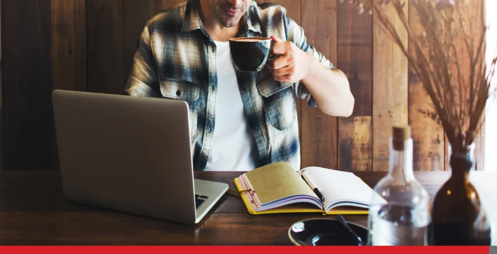 Man working on his laptop at a cafe.