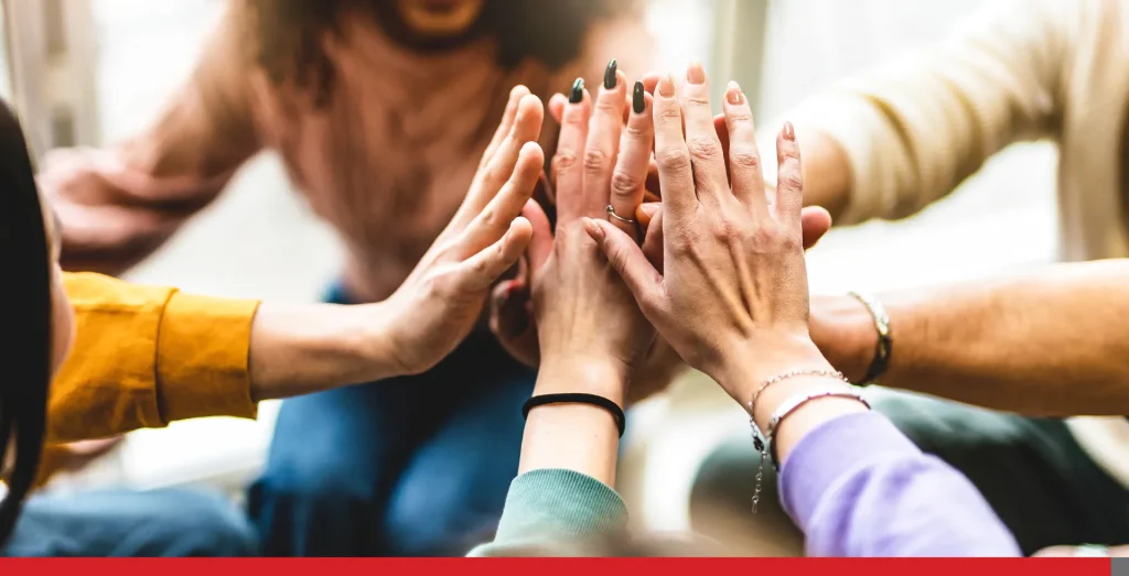 People holding hands together after a company success