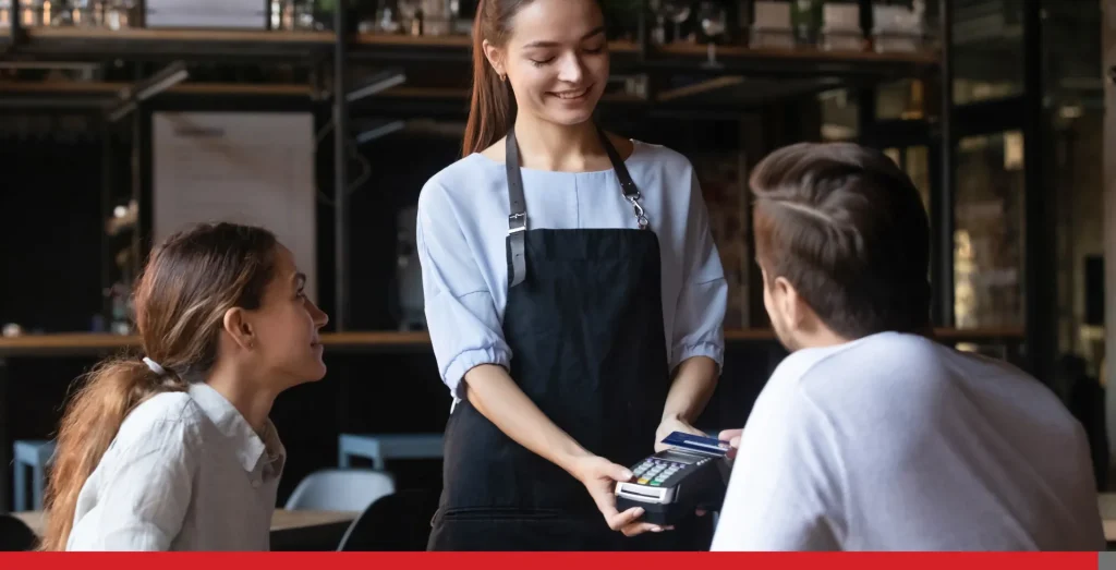 Customer paying by contactless credit card.