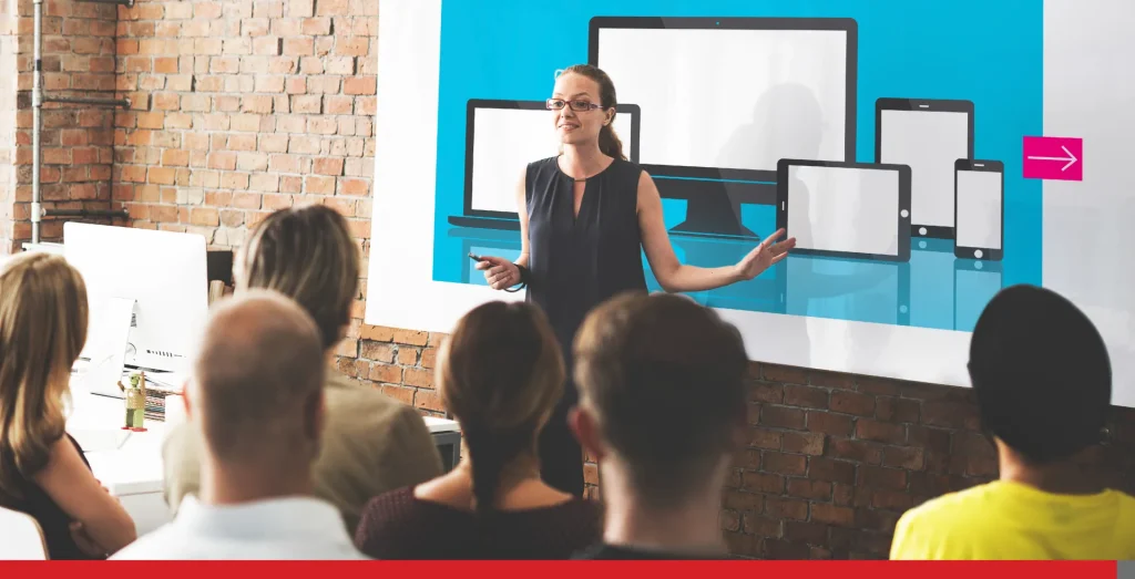 A business meeting with a whiteboard in the background. 