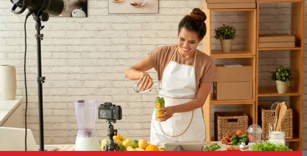 Food blogger cooking in front of a camera.