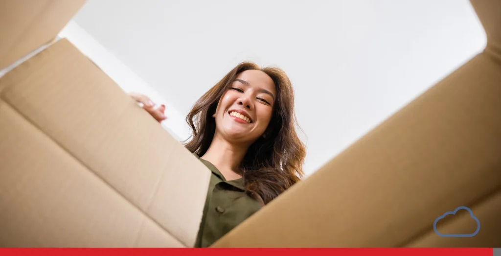 Woman checking the contents of a cardboard box 