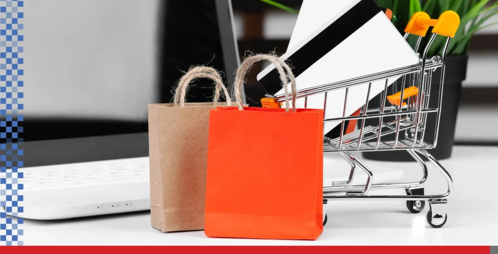 Shopping bags in front of a shopping cart.