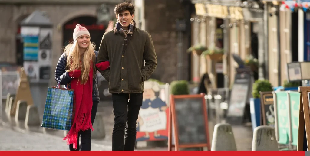 A young couple shops in Grassmarket in Edinburgh, Scotland.