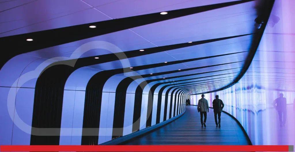 Two people walking along a futuristic pathway.