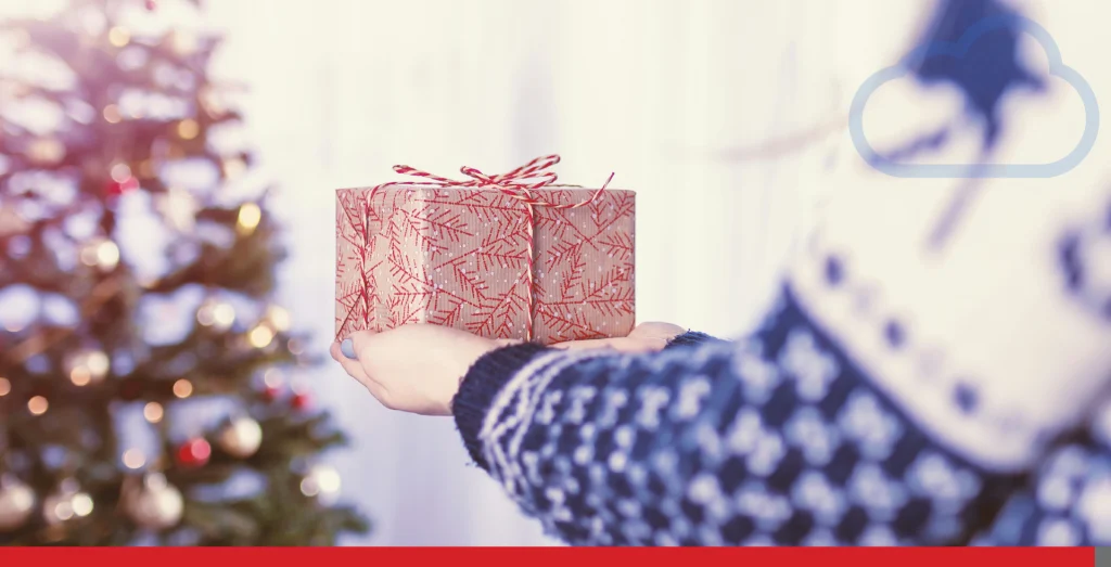 Someone carrying a gift to put under a Christmas tree