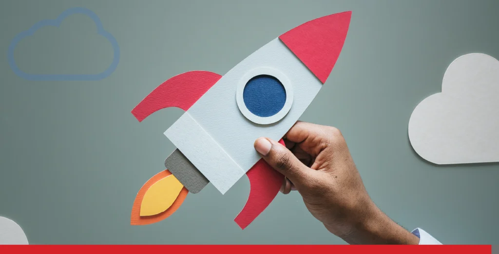 Hand holding rocketship to signify a business startup.