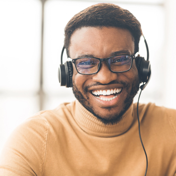 Person with headphones smiling